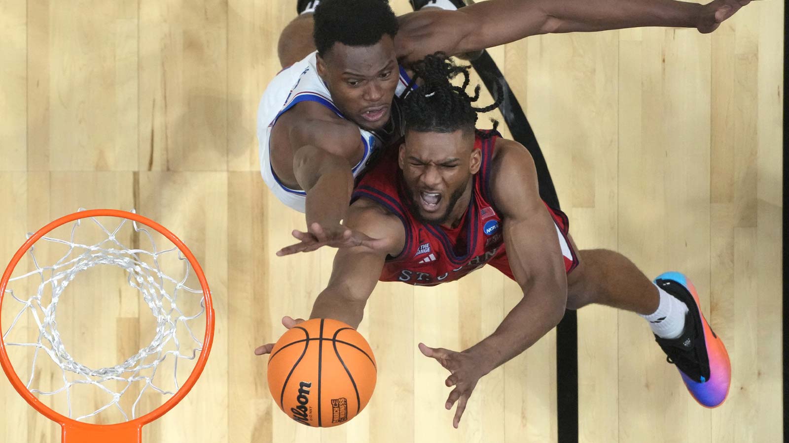 St. John's Red Storm forward Zuby Ejiofor (24) shoots against Kansas Jayhawks center Paul Mbiya (34) in the second half during a second round game of the men's 2026 NCAA Tournament at Viejas Arena.