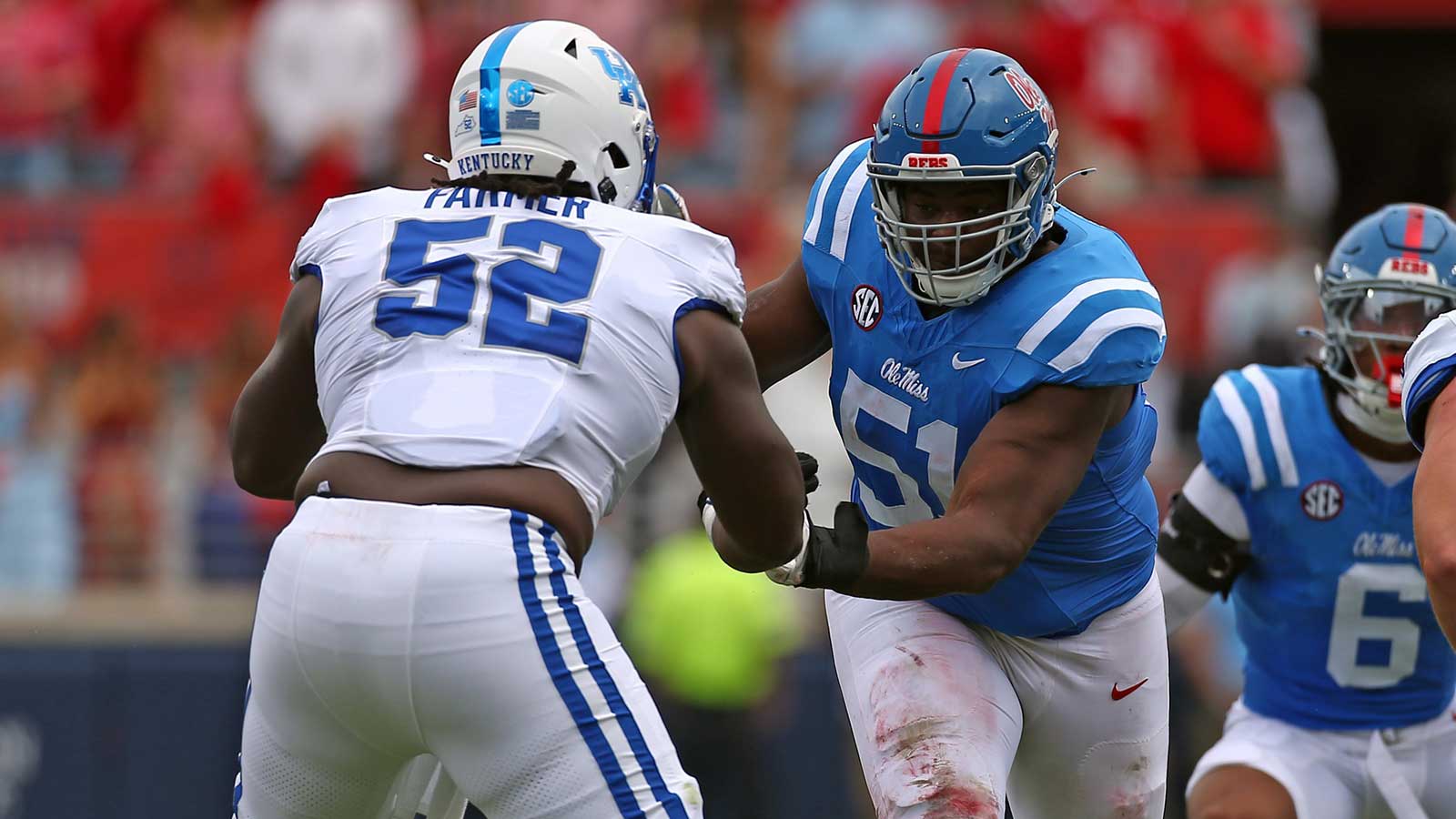 Mississippi Rebels defensive linemen Zxavian Harris (51) rushes as Kentucky Wildcats offensive lineman Jalen Farmer (52) blocks during the first half at Vaught-Hemingway Stadium. 