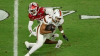 Indiana Hoosiers defensive back Jamari Sharpe (22) tackles Miami Hurricanes wide receiver CJ Daniels (7) in the third quarter during the College Football Playoff National Championship game at Hard Rock Stadium.