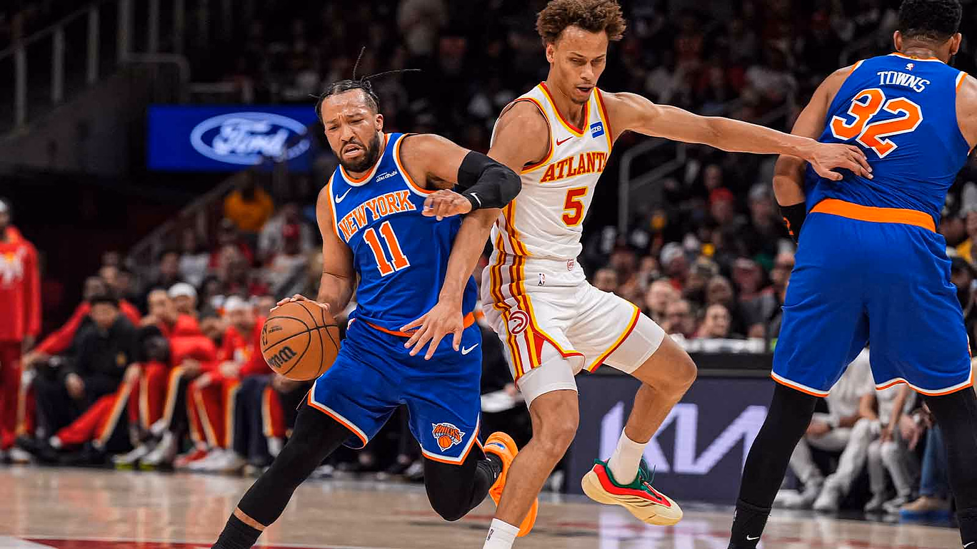 New York Knicks guard Jalen Brunson (11) tries to dribble past Atlanta Hawks guard Dyson Daniels (5) during the first half at State Farm Arena.