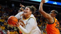 Iowa State Cyclones' center Audi Crooks (55) goes for a shot around Oklahoma State Cowgirls forward Achol Akot (11) and guard Stailee Heard (32) during the first quarter in the senior day women basketball at Hilton Coliseum on February. 25, 2026, in Ames, Iowa.