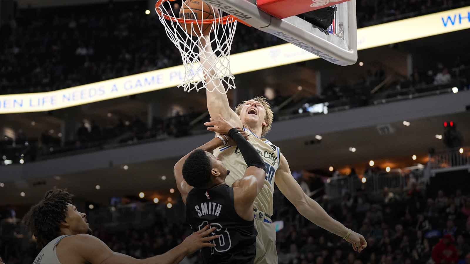Milwaukee Bucks guard AJ Green (20) tries to dunk over Brooklyn Nets guard Malachi Smith (18) during the second quarter at Fiserv Forum.