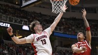 Arkansas Razorbacks guard Darius Acuff Jr. (5) shoots the ball against Arizona Wildcats center Motiejus Krivas (13) in the second half during a Sweet Sixteen game of the West Regional of the men's 2026 NCAA Tournament at SAP Center