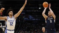 UConn Huskies forward Alex Karaban (11) shoots the ball over Duke Blue Devils forward Cameron Boozer (12) during an Elite Eight game of the East Regional of the men's 2026 NCAA Tournament at Capital One Arena.