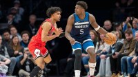 Minnesota Timberwolves guard Anthony Edwards (5) dribbles the ball as Chicago Bulls guard Tre Jones (30) defends in the second half at Target Center.