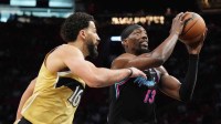 Miami Heat center Bam Adebayo (13) drives to the basket as Washington Wizards forward Anthony Gill (16) defends during the first half at Kaseya Center.