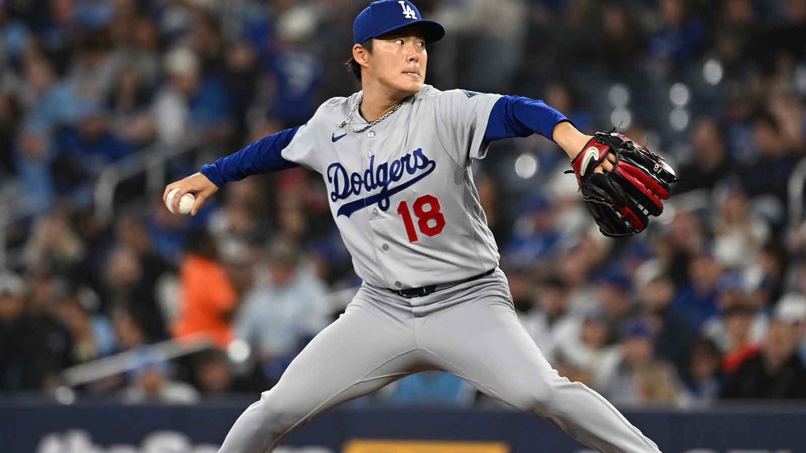 Los Angeles Dodgers starting pitcher Yoshinobu Yamamoto (18) delivers a pitch against the Toronto Blue Jays in the first inning at Rogers Centre. Mandatory Credit: Dan Hamilton-Imagn Images