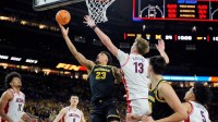 Michigan forward Yaxel Lendeborg (23) looks for a basket around Arizona center Motiejus Krivas (13) in the first half of their Final Four game at Lucas Oil Stadium in Indianapolis on Saturday, April 4, 2026.