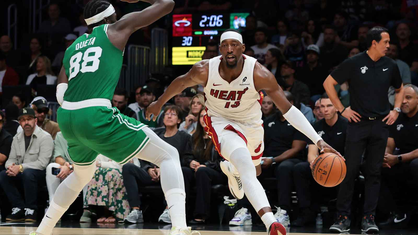 Miami Heat center Bam Adebayo (13) drives to the basket against Boston Celtics center Neemias Queta (88) during the first quarter at Kaseya Center.