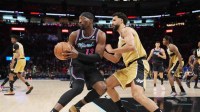 Miami Heat center Bam Adebayo (13) looks to pass the ball as Washington Wizards forward Anthony Gill (16) defends during the first half at Kaseya Center.