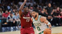Boston Celtics forward Jayson Tatum (0) drives to the basket past Miami Heat center Bam Adebayo (13) during the first quarter at Kaseya Center.