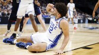 Duke Blue Devils forward Cameron Boozer (12) reacts after being injured while shooting the ball against the UConn Huskies in the first half during an Elite Eight game of the East Regional of the men's 2026 NCAA Tournament at Capital One Arena.