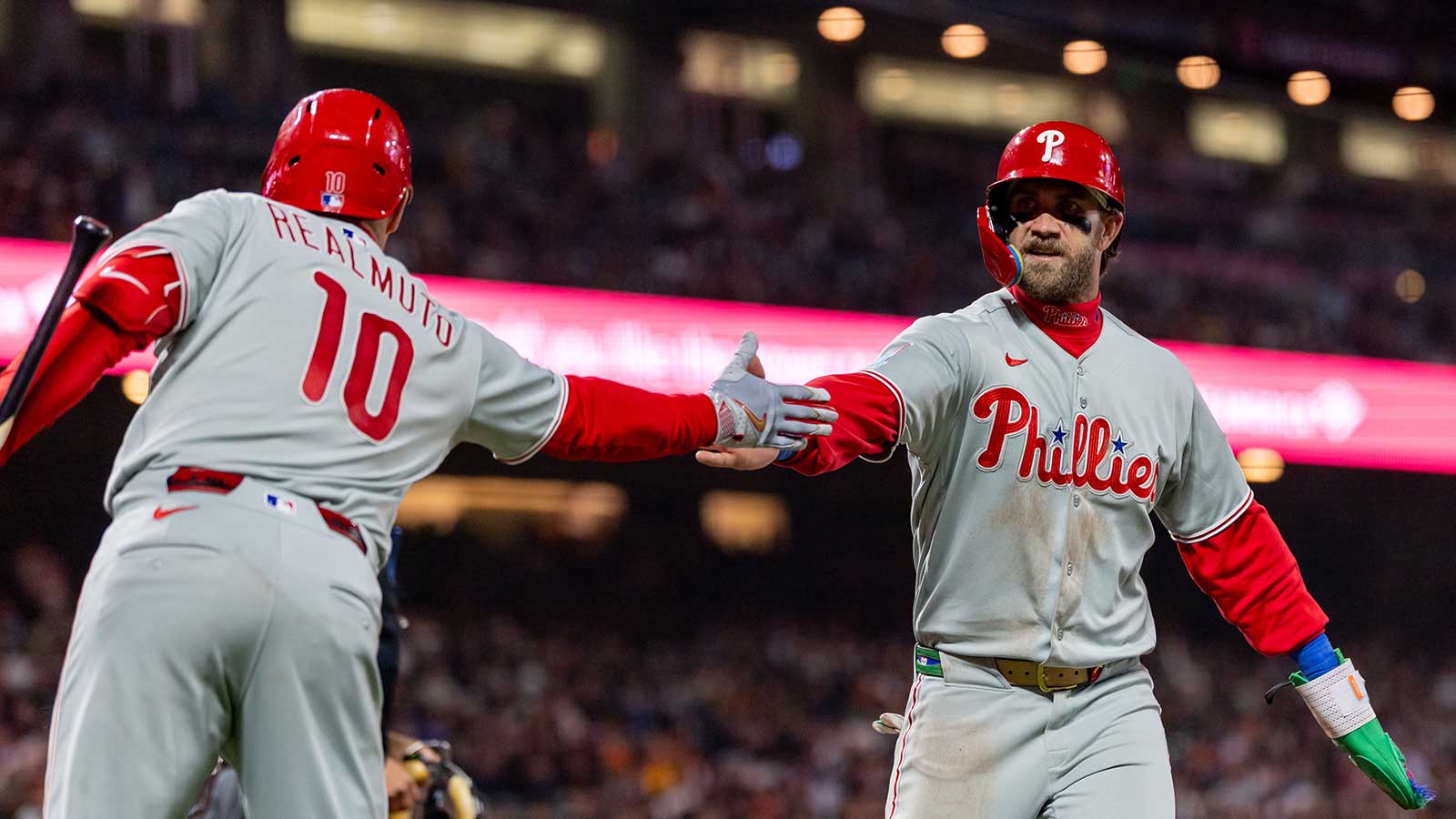 Philadelphia Phillies first baseman Bryce Harper (3) celebrates scoring during the seventh inning against the San Francisco Giants at Oracle Park.