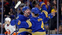 Buffalo Sabres defenseman Bowen Byram (4) celebrates his open net goal with defenseman Mattias Samuelsson (23) during the third period against the New York Islanders at KeyBank Center.