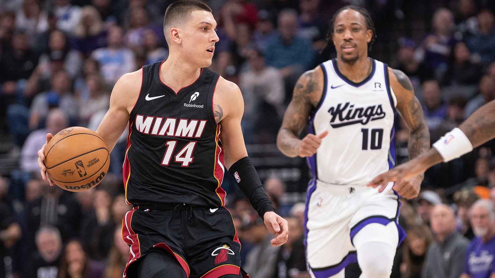 Miami Heat guard Tyler Herro drives past Sacramento Kings forward DeMar DeRozan.