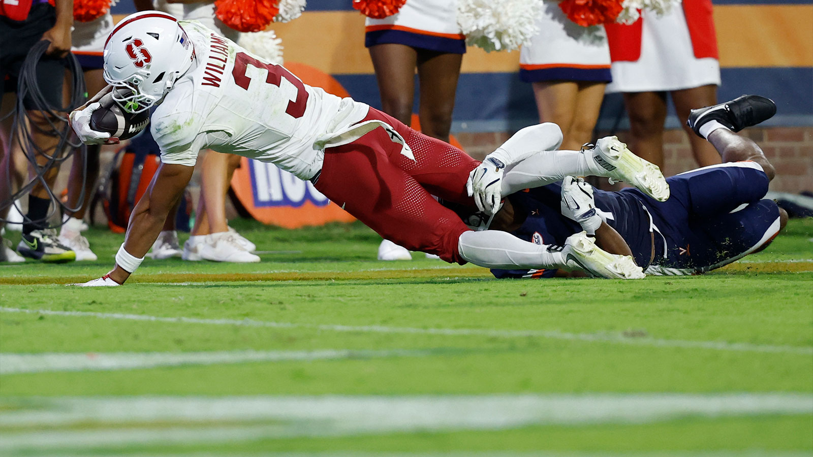 Stanford Cardinal wide receiver C.J. Williams (3) is tackled by Virginia Cavaliers defensive back Christian Charles (4) while diving for the end zone during the second quarter at Scott Stadium. 