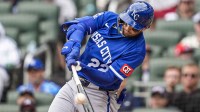 Kansas City Royals catcher Carter Jensen (22) drives in a run with a sacrifice fly against the Atlanta Braves during the eighth inning at Truist Park.