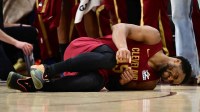 Cavaliers guard Donovan Mitchell (45) lies on the court