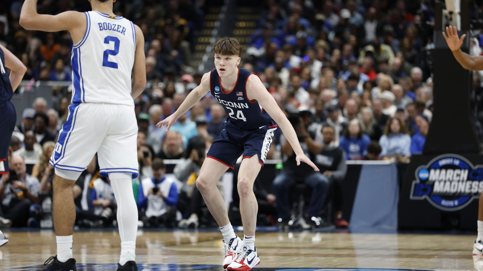 UConn Huskies guard Braylon Mullins (24) defends Duke Blue Devils guard Cayden Boozer (2) in the second half during an Elite Eight game of the East Regional of the men's 2026 NCAA Tournament at Capital One Arena. 