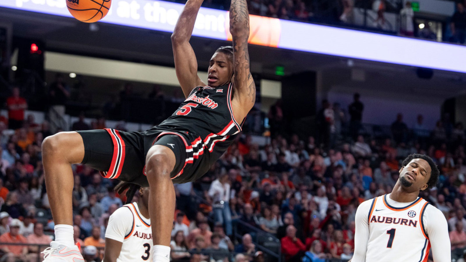 Houston Cougars center Chris Cenac Jr. (5) dunks the ball as Auburn Tigers take on the Houston Cougars at Legacy Arena in Birmingham, Ala. on Sunday, Nov. 16, 2025. Houston Cougars defeated Auburn Tigers 73-72.