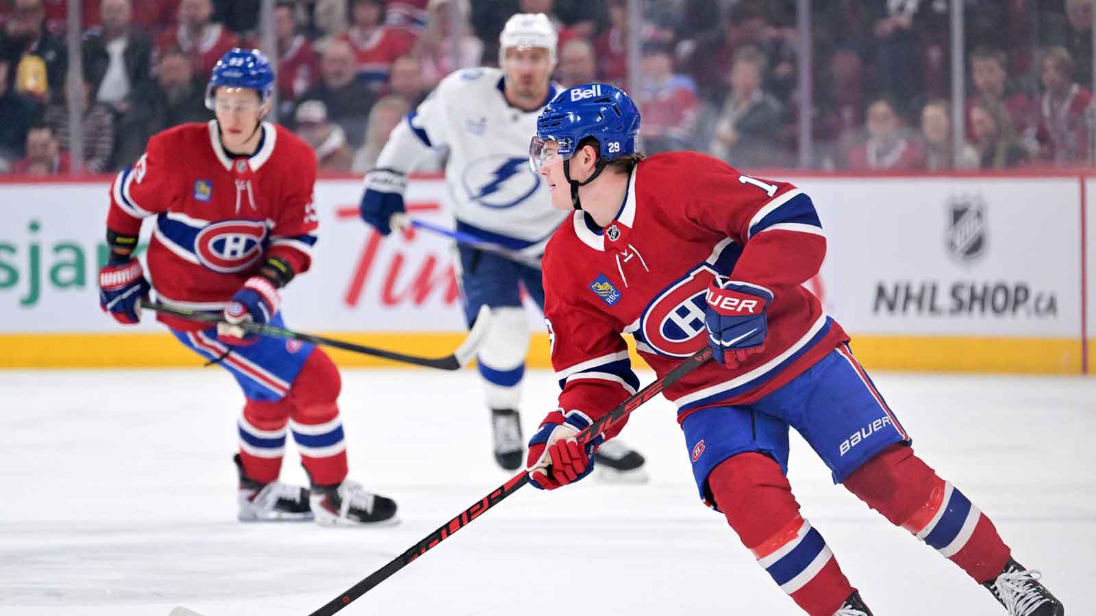 Montreal Canadiens forward Cole Caufield (13) plays the puck during the first period of the game against the Tampa Bay Lightning at the Bell Centre