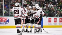 Chicago Blackhawks center Ryan Donato (8) and center Connor Bedard (98) and defenseman Sam Rinzel (6) and center Teuvo Teravainen (86) and left wing Tyler Bertuzzi (59) and center Frank Nazar (91) celebrate a goal during the game between the Stars and the Blackhawks at American Airlines Center.