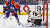 Chicago Blackhawks goaltender Spencer Knight (30) makes a save on Edmonton Oilers forward Connor McDavid (97) during the third period at Rogers Place.