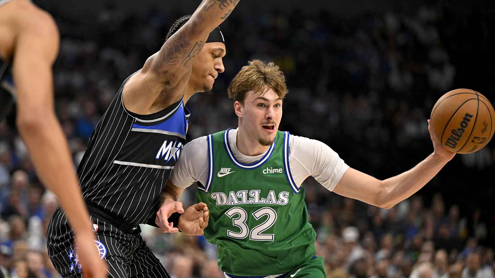 Dallas Mavericks forward Cooper Flagg (32) passes the ball by Orlando Magic forward Paolo Banchero (5) during the second quarter at the American Airlines Center.