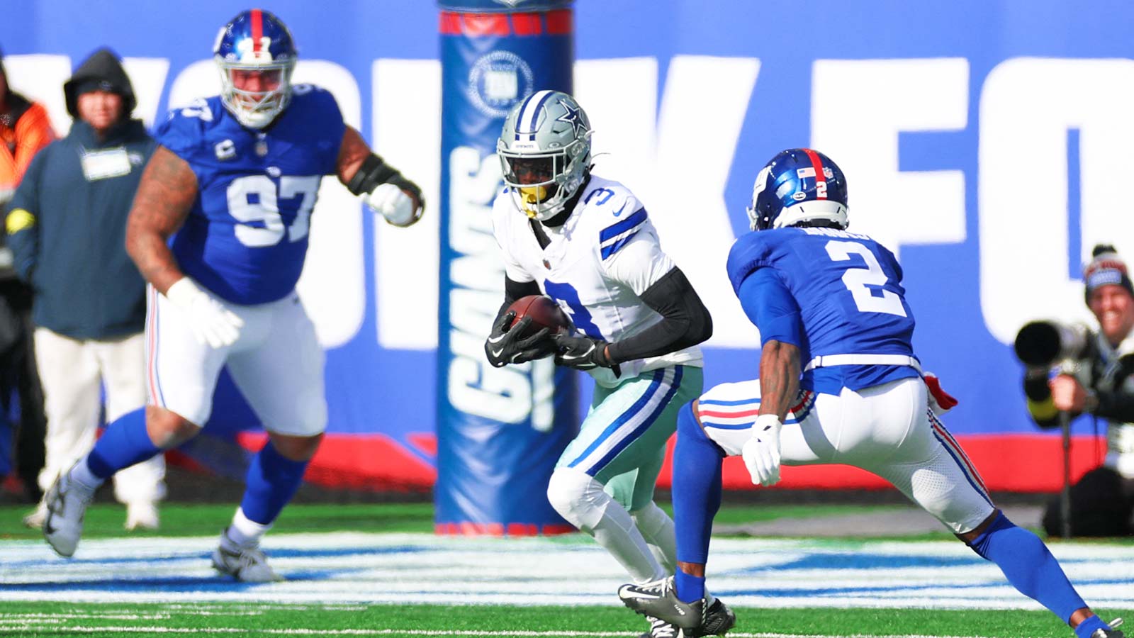 Dallas Cowboys wide receiver George Pickens (3) runs after making a catch as New York Giants cornerback Deonte Banks (2) defends during the first quarter at MetLife Stadium.