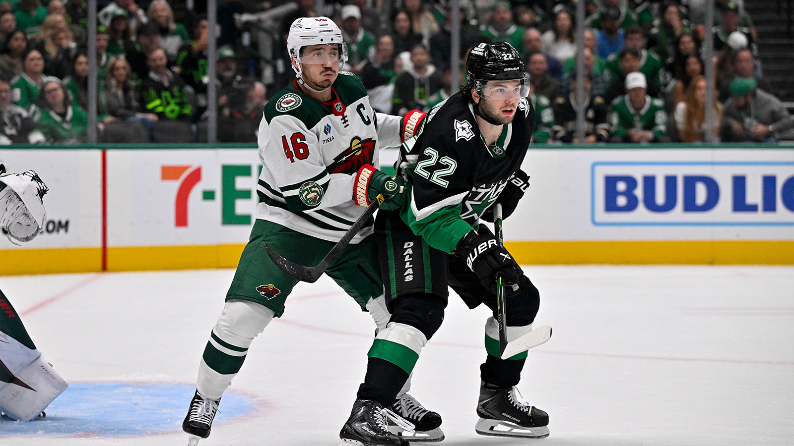 Minnesota Wild defenseman Jared Spurgeon (46) and Dallas Stars center Mavrik Bourque (22) look for the puck during the second period in game five of the first round of the 2026 Stanley Cup Playoffs at American Airlines Center. 