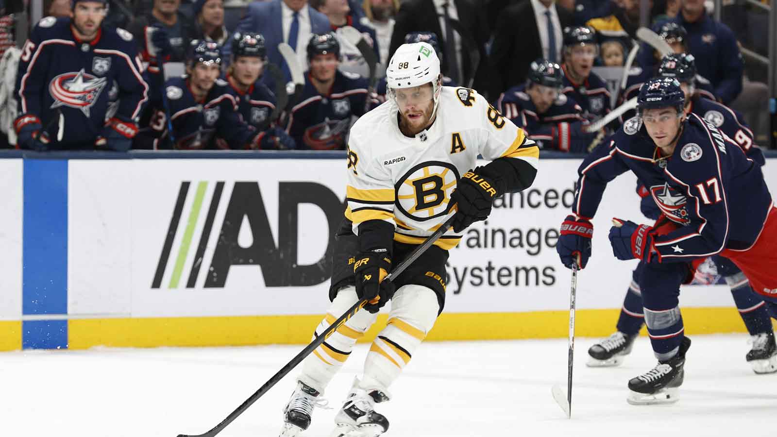 Boston Bruins right wing David Pastrnak (88) skates with the puck as Columbus Blue Jackets left wing Mason Marchment (17) trails the play during the first period at Nationwide Arena. 