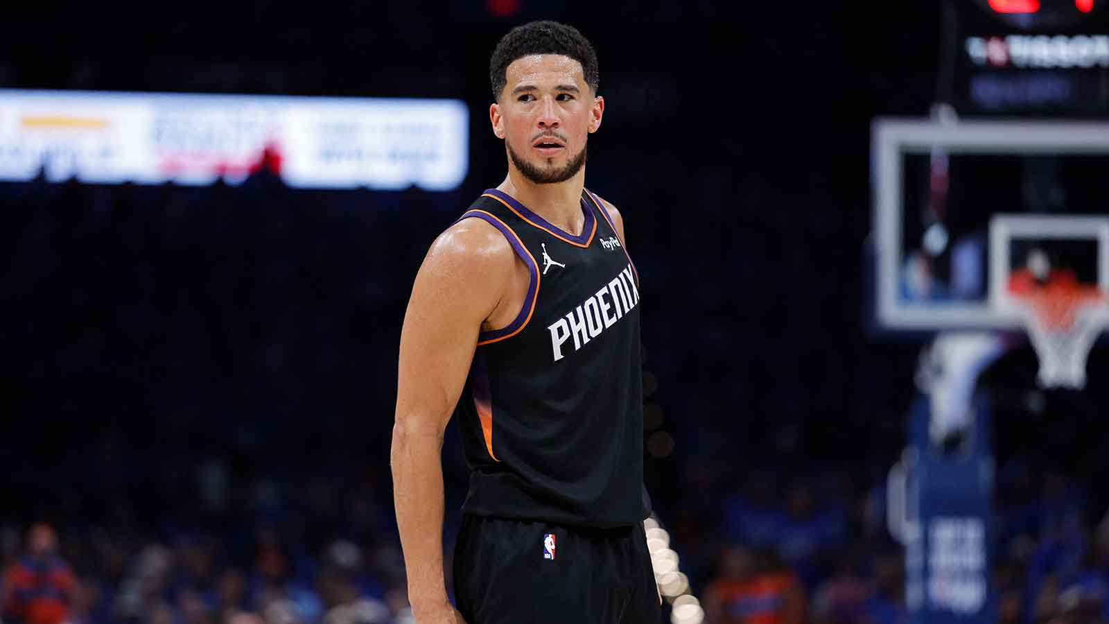 Phoenix Suns guard Devin Booker (1) looks down the court against the Oklahoma City Thunder in the second half during game one of the first round of the 2026 NBA Playoffs at Paycom Center.
