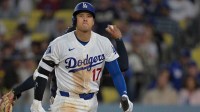 Los Angeles Dodgers two-way player Shohei Ohtani (17) returns to the dugout after he was called out on a checked swing with bases loaded to end in the eighth inning against the Cleveland Guardians at Dodger Stadium.