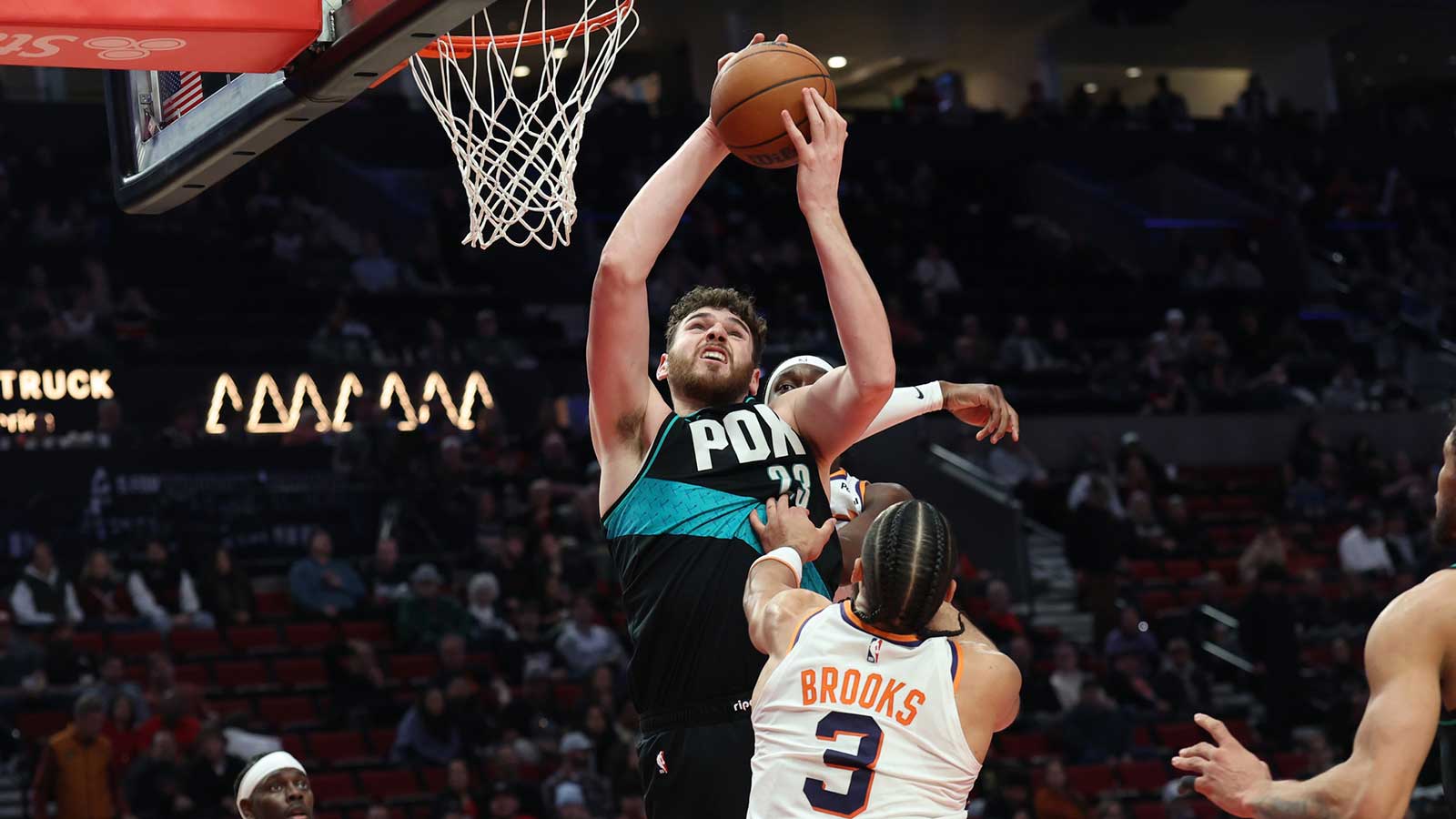 Portland Trail Blazers center Donovan Clingan (23) grabs a rebound over Phoenix Suns guard/forward Dillon Brooks (3) during the second half at Moda Center.