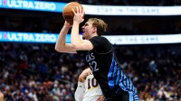 Dallas Mavericks forward Cooper Flagg (32) shoots past Los Angeles Lakers guard Luke Kennard (10) during the first half at American Airlines Center.