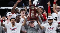 Florida Atlantic Owls head coach Dusty May hoists the East Regional Champion trophy following their 79-76 victory against the Kansas State Wildcats in an NCAA tournament East Regional final at Madison Square Garden.
