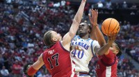 Kansas Jayhawks forward Flory Bidunga (40) shoots against St. John's Red Storm forward Rubén Prey (17) and forward Bryce Hopkins (23) in the second half during a second round game of the men's 2026 NCAA Tournament at Viejas Arena.