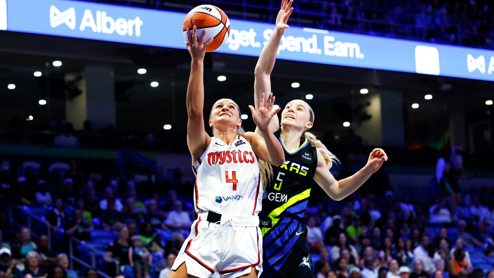 Former Washington Mystics guard Jacy Sheldon (4) shoots as Dallas Wings guard Paige Bueckers (5) defends during the first half at College Park Center.