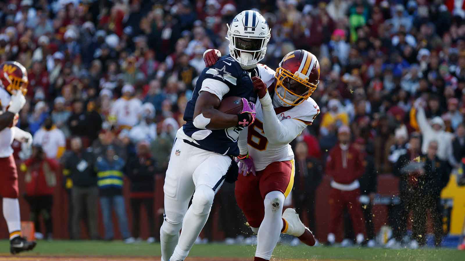 Dallas Cowboys wide receiver George Pickens (3) carries the ball as Washington Commanders cornerback Noah Igbinoghene (6) defends during the first half at Northwest Stadium.
