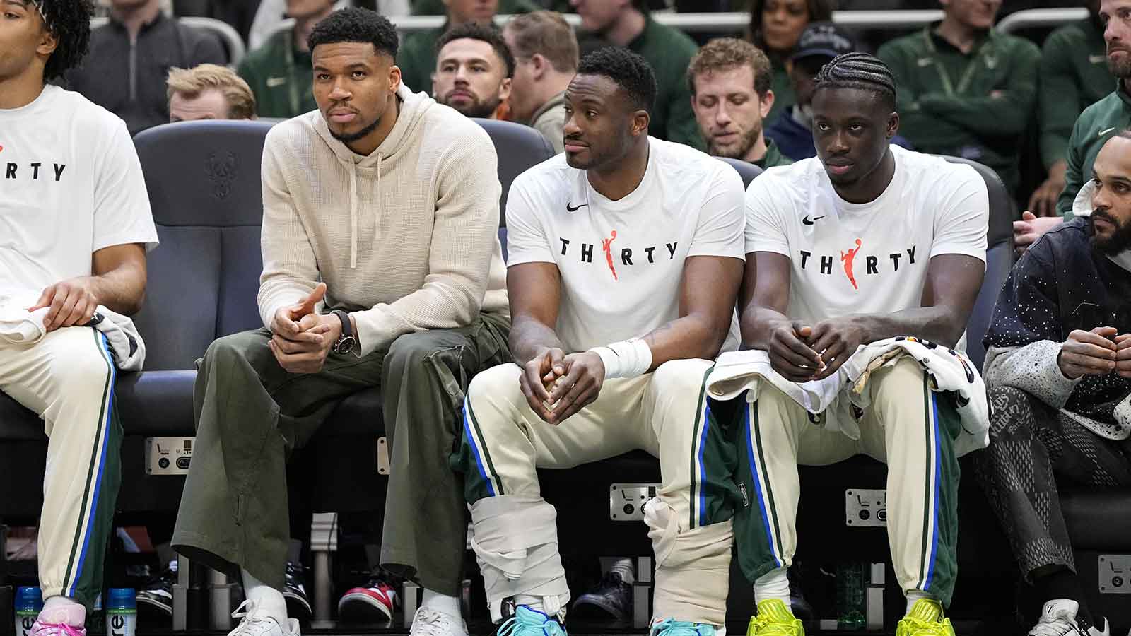 Milwaukee Bucks forward Giannis Antetokounmpo (34), forward Thanasis Antetokounmpo (43) and forward Alex Antetokounmpo (29) sit on the bench during the first quarterq against the Brooklyn Nets at Fiserv Forum.