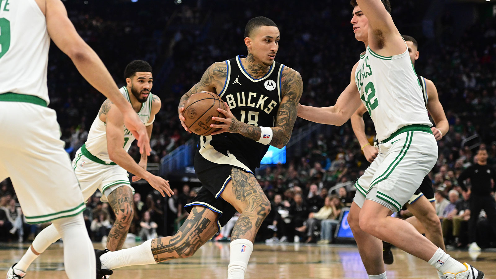 Milwaukee Bucks forward Kyle Kuzma (18) drives for the basket against Boston Celtics forward Luka Garza (52) in the second quarter at Fiserv Forum.