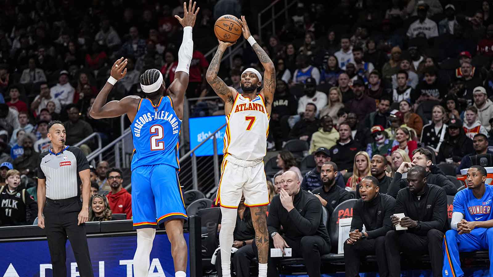 Hawks guard Nickeil Alexander-Walker (7) shoots over Oklahoma City Thunder guard Shai Gilgeous-Alexander (2) during the first half at State Farm Arena
