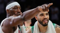 Miami Heat center Bam Adebayo (13) signals while speaking to Boston Celtics forward Jayson Tatum (0) after the game at Kaseya Center.