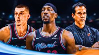 Miami Heat star Bam Adebayo in the center with Tyler Herro and Erik Spoelstra on either side in front of Kaseya Center.