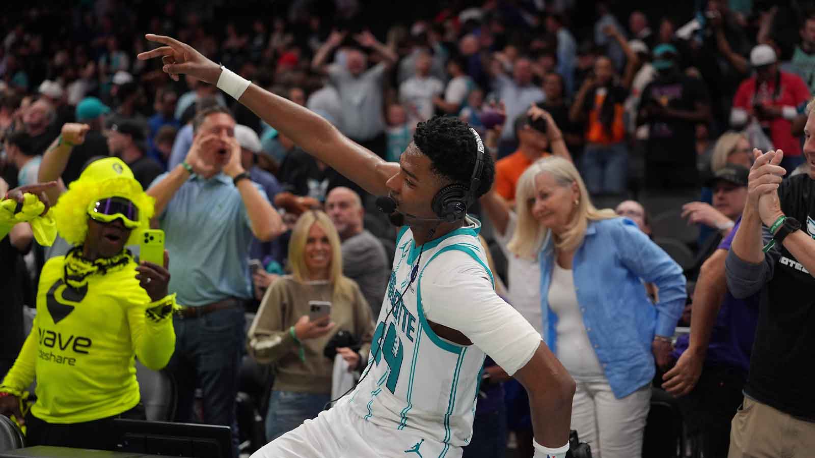 Hornets forward Brandon Miller (24) and fans react to the overtime win during the play-in rounds between the Charlotte Hornets and the Miami Heat of the 2026 NBA Playoffs at Spectrum Center