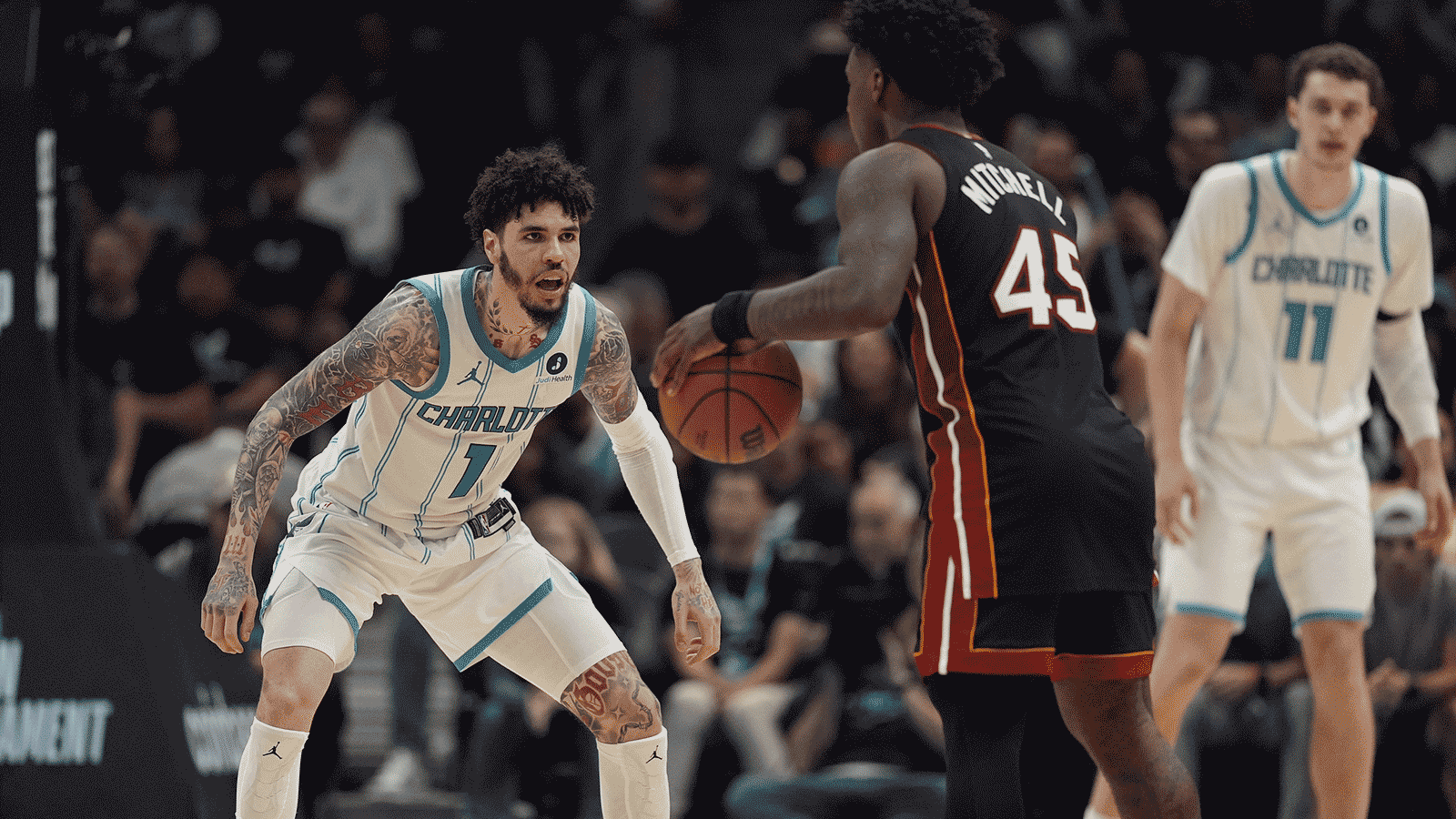 Hornets guard LaMelo Ball (1) defends against Miami Heat guard Davion Mitchell (45) during the second half during the play-in rounds between the Charlotte Hornets and the Miami Heat of the 2026 NBA Playoffs at Spectrum Center