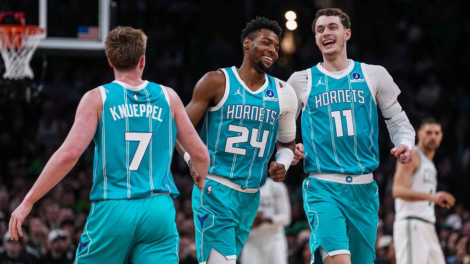 Hornets center Ryan Kalkbrenner (11), forward Brandon Miller celebrate