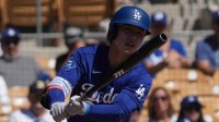 Los Angeles Dodgers second baseman Hyeseong Kim (6) hits against the Athletics in the first inning at Camelback Ranch-Glendale.