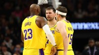 Los Angeles Lakers forward LeBron James (23) with guard Luka Doncic (77) and guard Austin Reaves (15) against the Phoenix Suns at Mortgage Matchup Center.