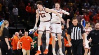 Illinois Fighting Illini center Zvonimir Ivisic (44) and forward Ben Humrichous (3) celebrate after defeating the Iowa Hawkeyes in an Elite Eight game of the South Regional of the men's 2026 NCAA Tournament at Toyota Center.